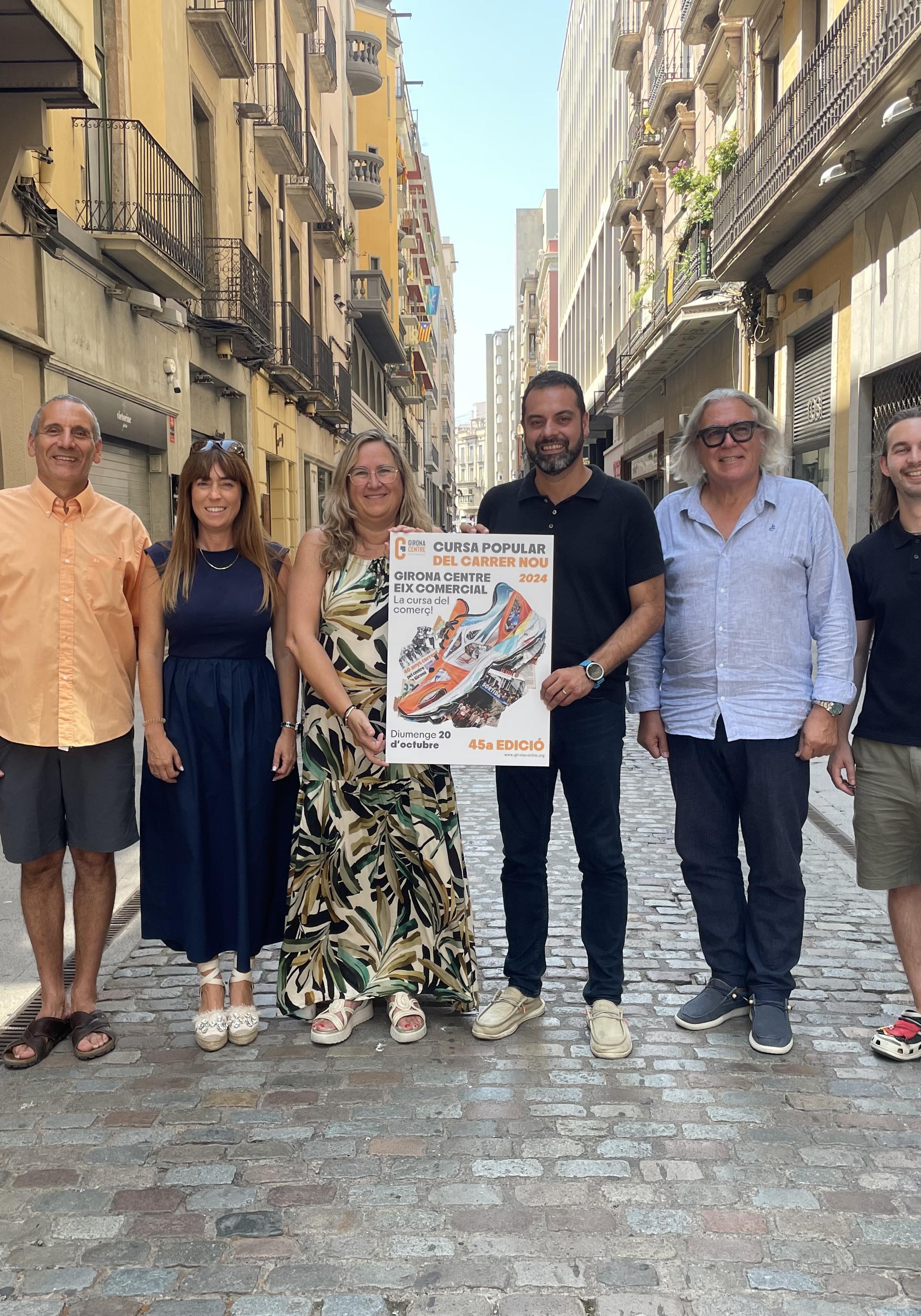 Presentació del cartell 2024 de la cursa popular del carrer Nou de Girona. Els representants de Girona Centre Eix Comercial i l’Ajuntament de Girona (al centre) acompanyats pel dissenyador del cartell (a la dreta) i el representant de l’organització tècnica de la prova (a l’esquerra).